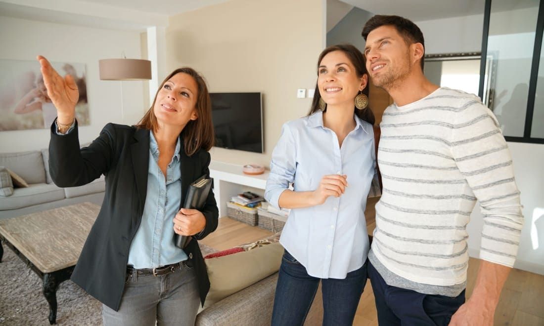 Estate agent showing a couple around a bright Dutch apartment